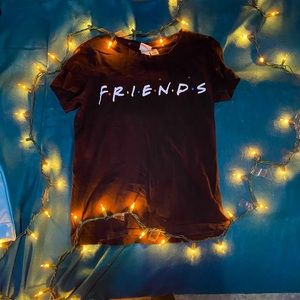 black tee shirt that says “F R I E N D S”